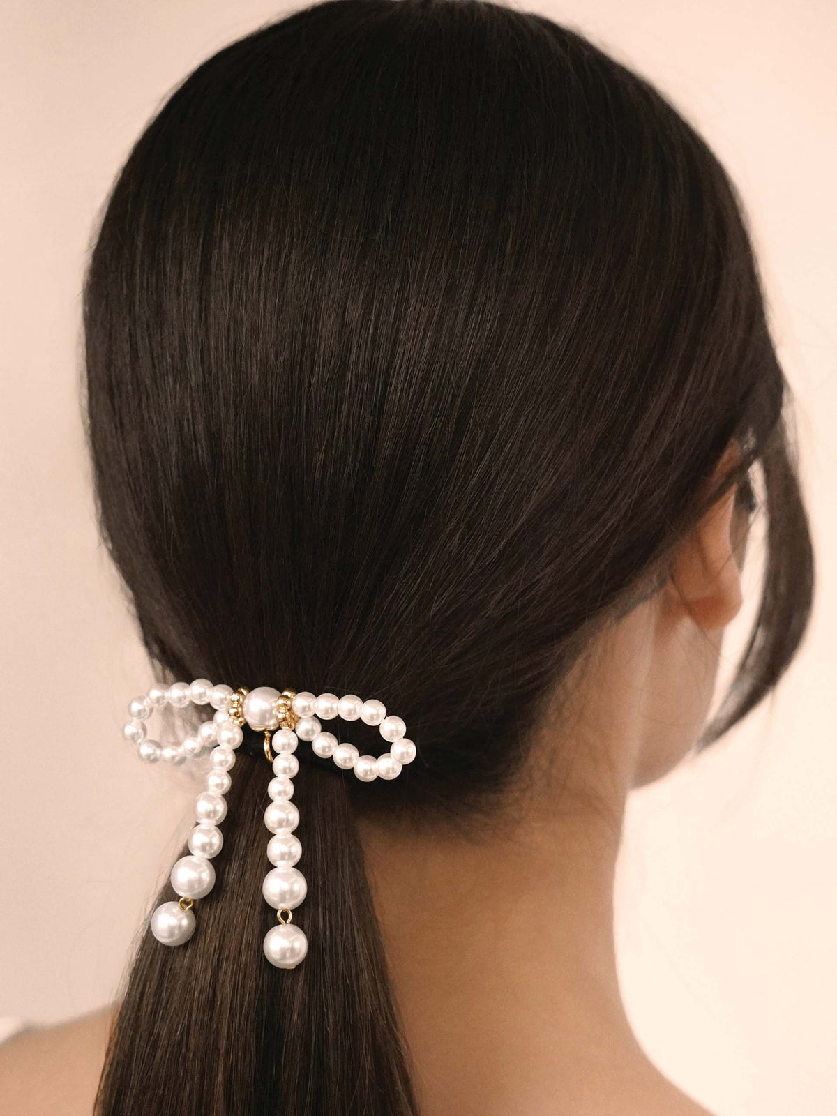 Aurora Pearl Bow Hair Tie - Gold Tone with Black Elastic | Ettika